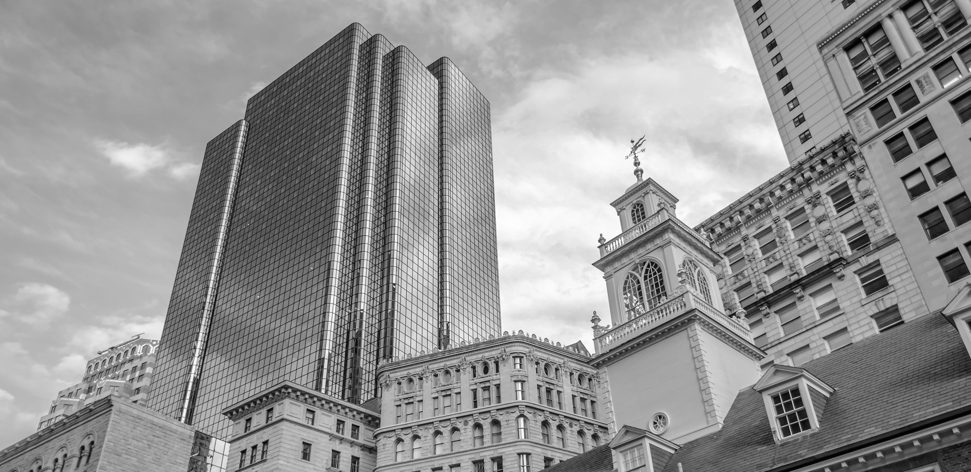 A black and white photo of the old Boston State house.