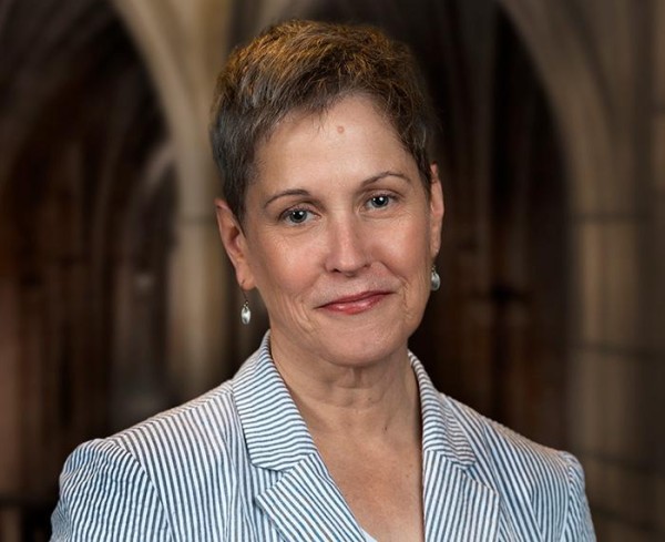 A photo of a person in a striped blazer.