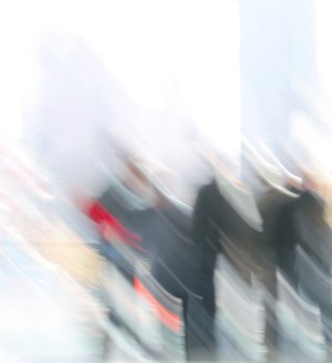 A group of blurred people against a white background.